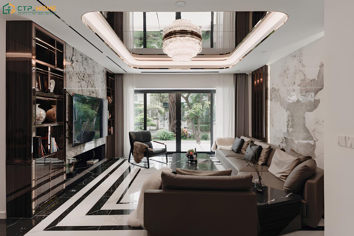 Phòng khách được hoàn thiện với hệ vách đá khổ lớn và tủ trang trí âm tường đối xứng
