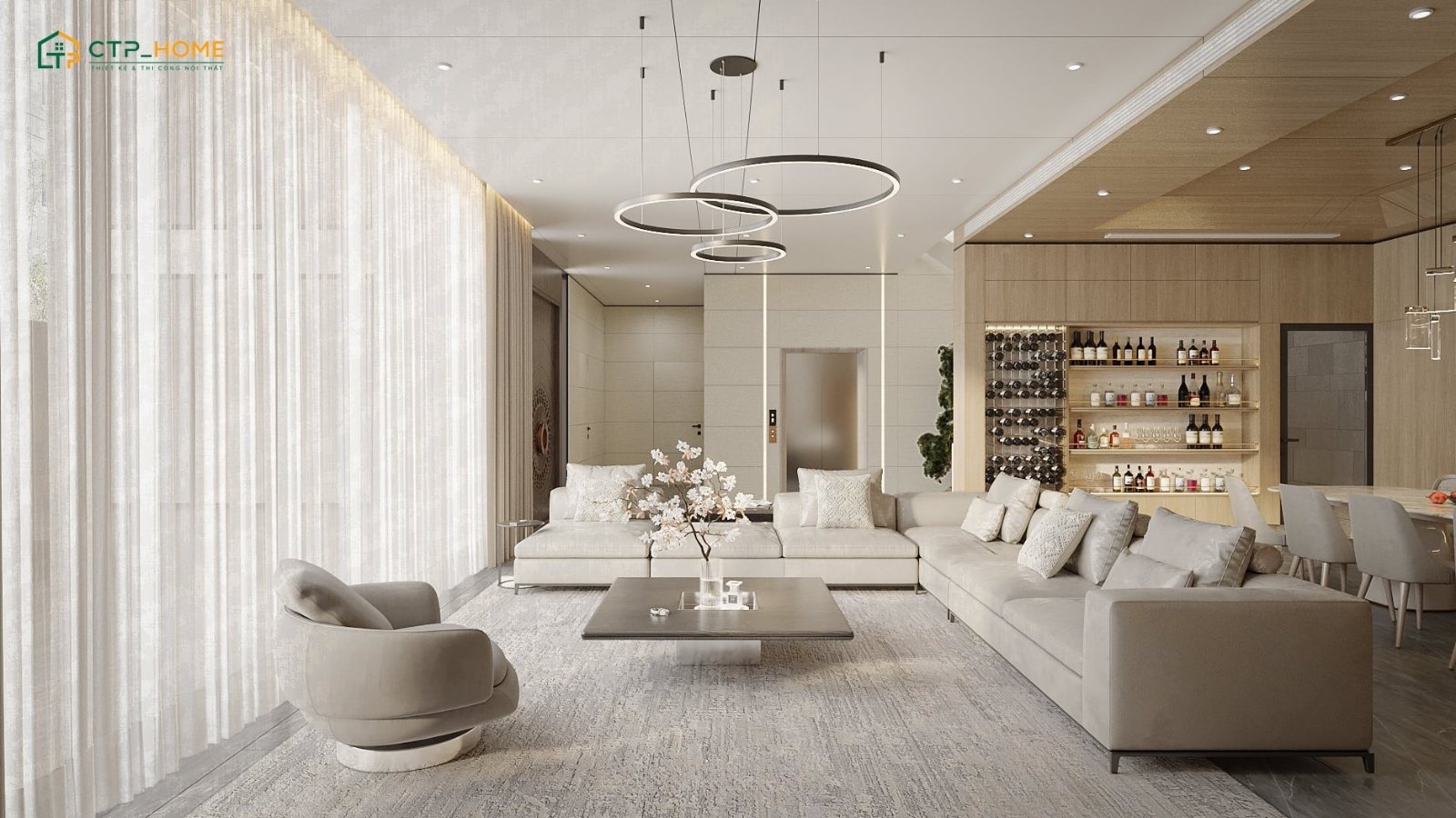 Không gian được bố trí theo xu hướng mở với bộ sofa kết nối hài hòa cùng bàn trà và quầy bar