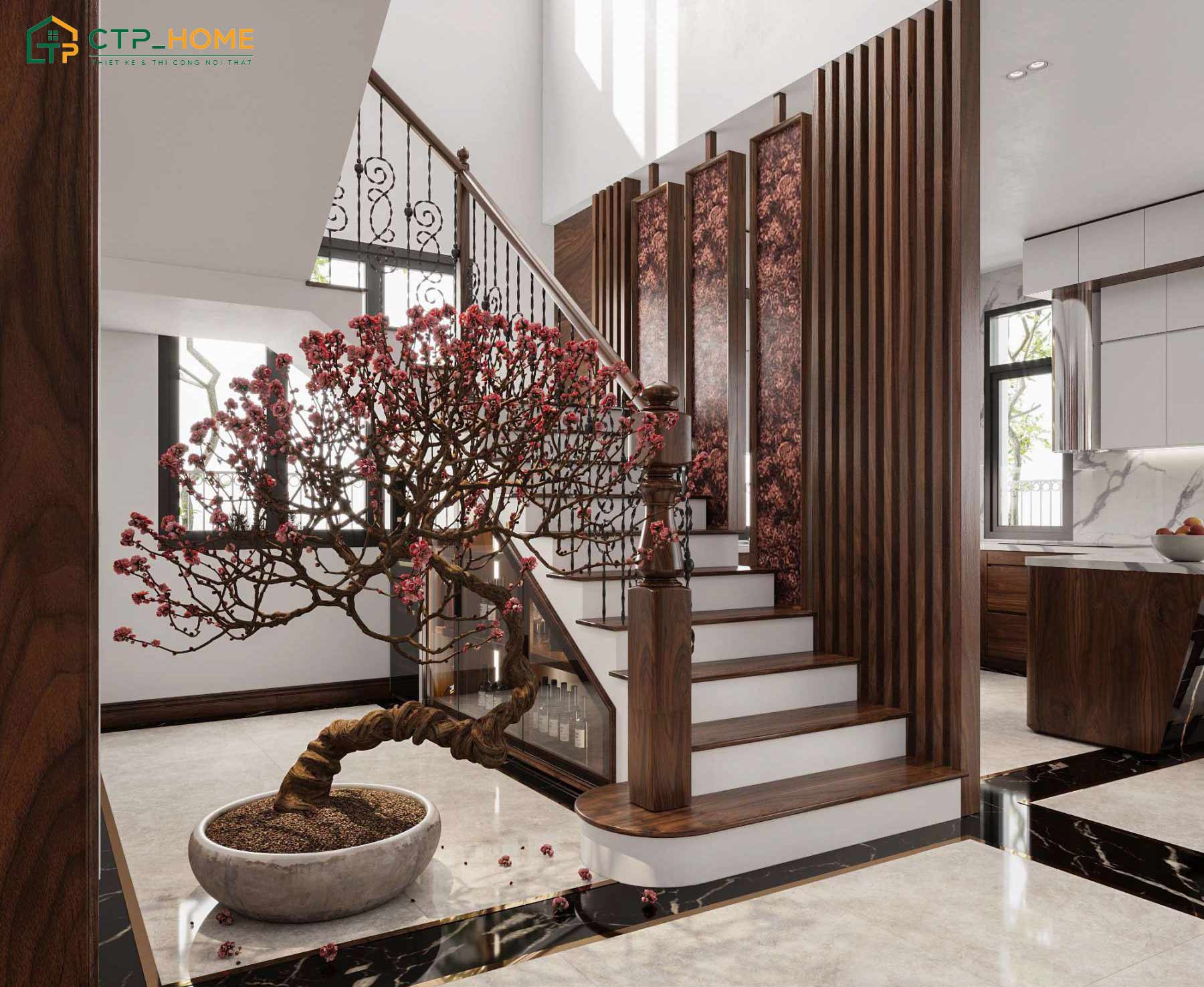 CTP Home sử dụng vách gỗ óc chó để ngăn cách cầu thang với bếp để giúp không gian trở nên thoáng đãng hơn