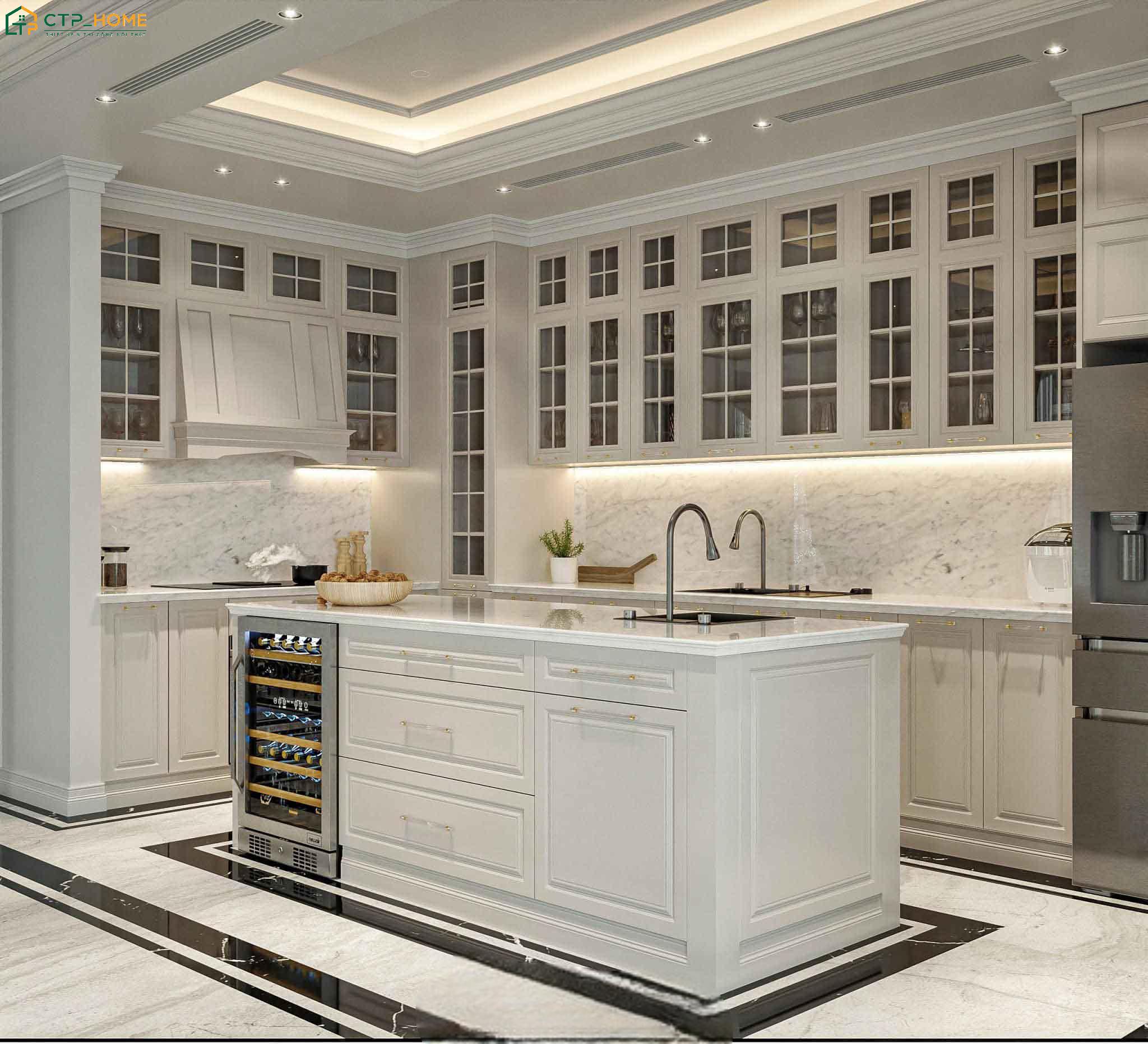 Hệ tủ bếp được thiết kế theo bố cục cân đối, kết hợp với các đường phào chỉ đặc trưng của phong cách tân cổ điển