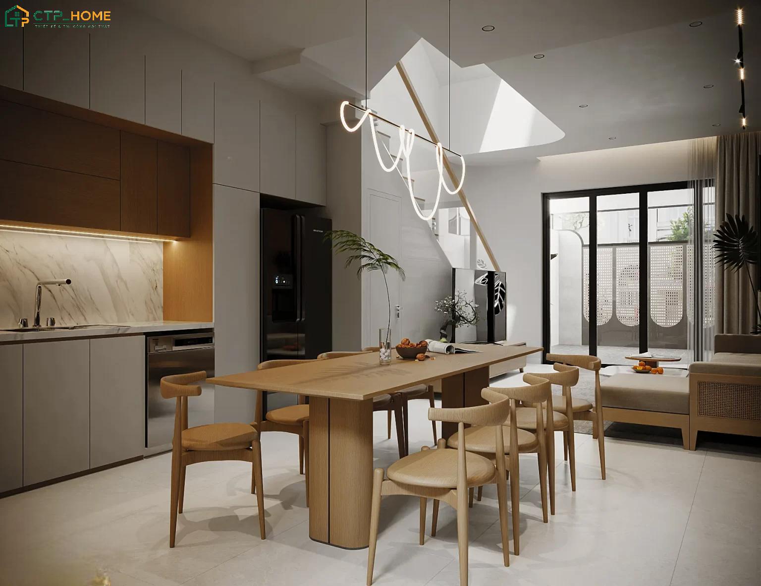 Bàn ăn đặt giữa phòng bếp và khách vừa tạo sự phân chia vừa giữ được sự kết nối cho căn nhà